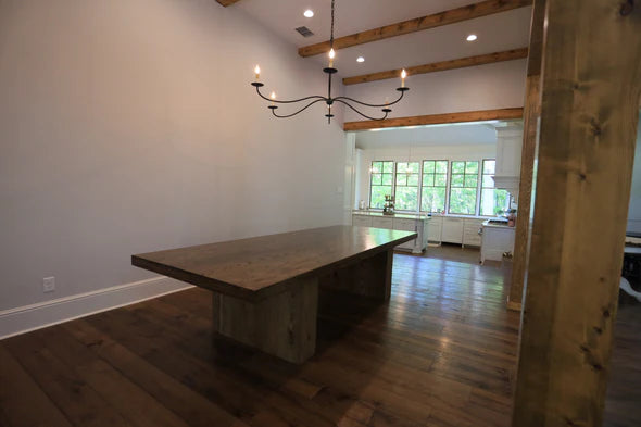 hardwood dining table dark brown color no chairs on dark brown hardwood floor in large room