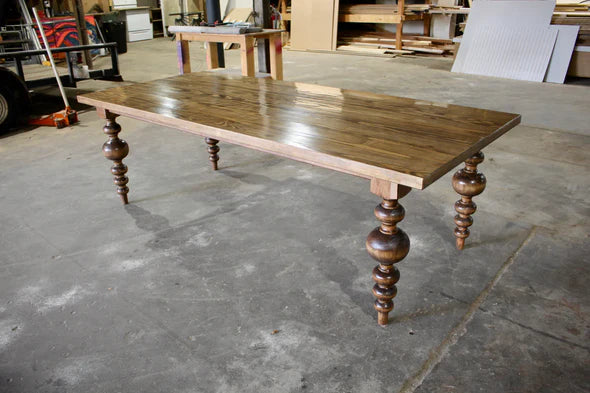 hardwood dining table light brown stain on concrete shop floor