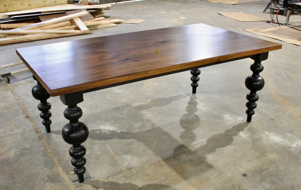 Hardwood dining table brown top with large dark turned legs 