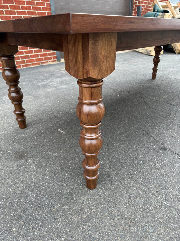 hardwood dining table dark brown stain close up of table leg