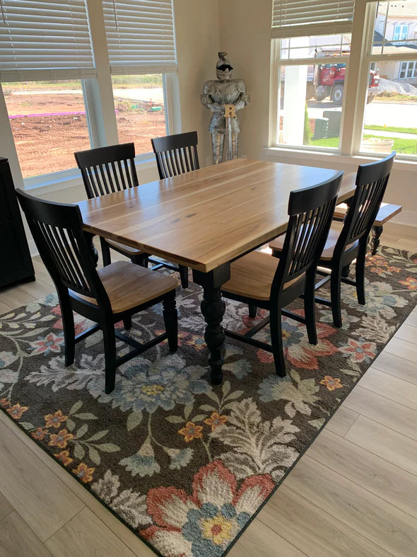 hardwood dining table natural oak colored top with black legs 5 black chairs and a matching bench